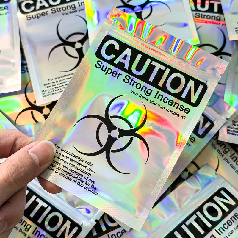 Holographic resealable Mylar seed storage bags with iridescent finish and caution-style design, suitable for small collectible seed storage