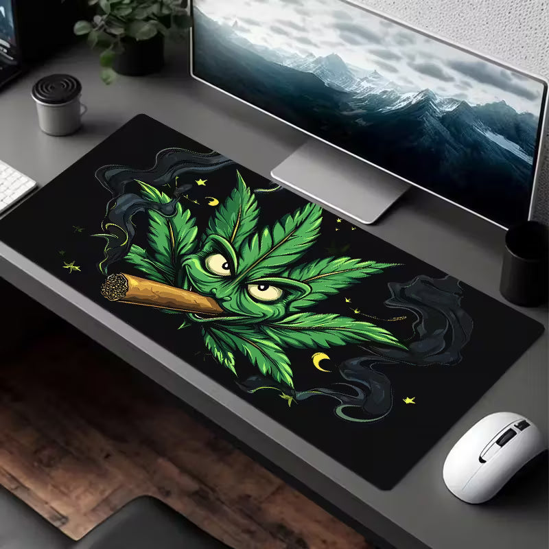 Large cannabis leaf and cigar graphic mouse pad on a desk surface