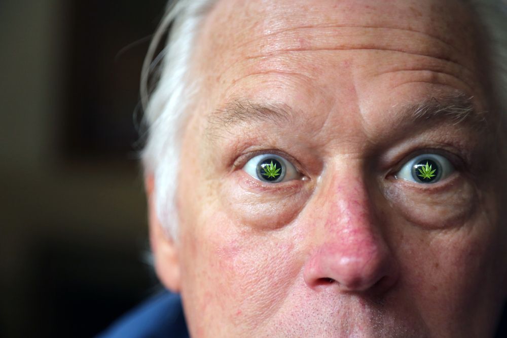 Close-up of an older man’s startled facial expression with cannabis eyes.