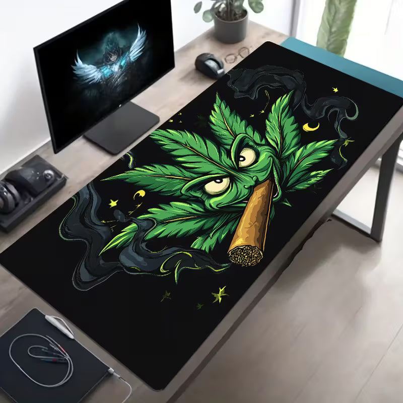 Desk setup with a large decorative mat featuring a cannabis leaf design.
