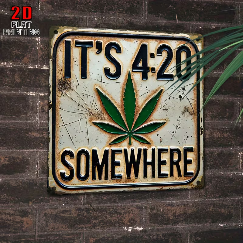Decorative sign with a cannabis leaf and text 'It's 4:20 Somewhere' on a textured background.
