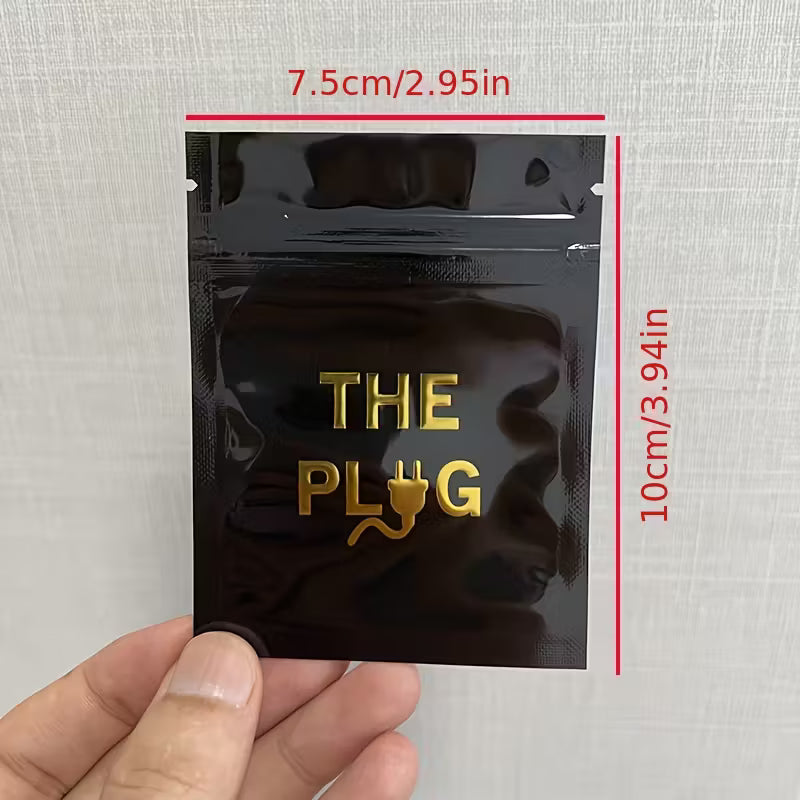 Black packaging with 'THE PLUG' text and measurements on a textured white background