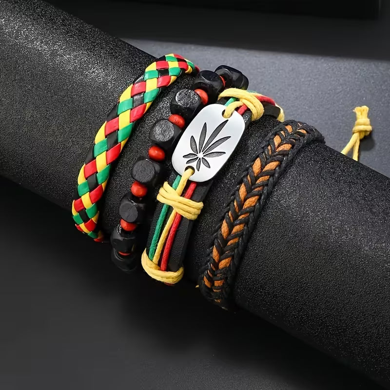 Colorful braided bracelets with a central silver leaf charm on a black surface