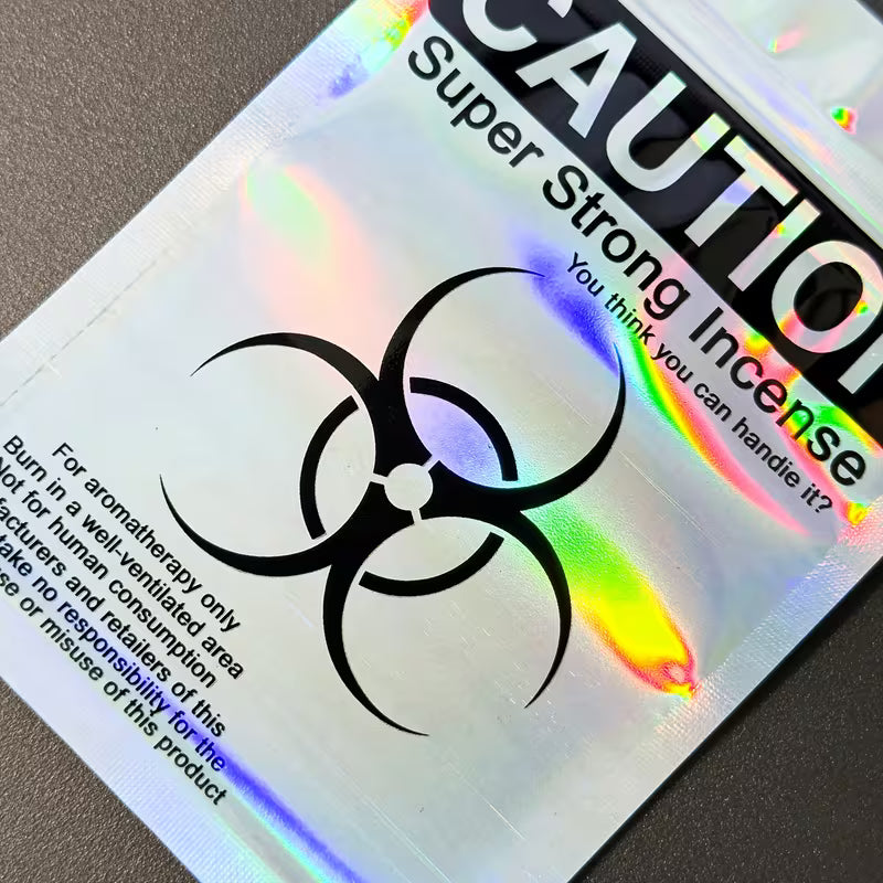 Holographic resealable Mylar seed storage bags with iridescent finish and caution-style design, suitable for small collectible seed storage