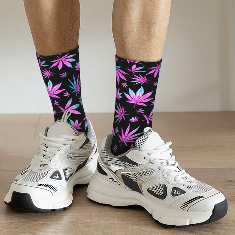 Pink and blue cannabis leaf socks black background on with trainers